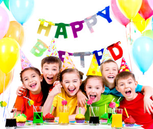 Group of laughing kids having fun at the birthday party - isolated on a white.