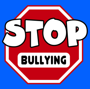 A octagonal Stop sign in red and white with Bullying caption on a blue background.