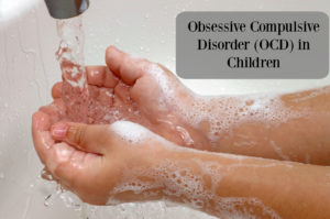 Closeup of a child's soapy hands being washed under running water in a sink