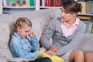 Child psychologist with a little girl, a child is crying