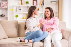 A happy family. Mother and teen daughter at home.